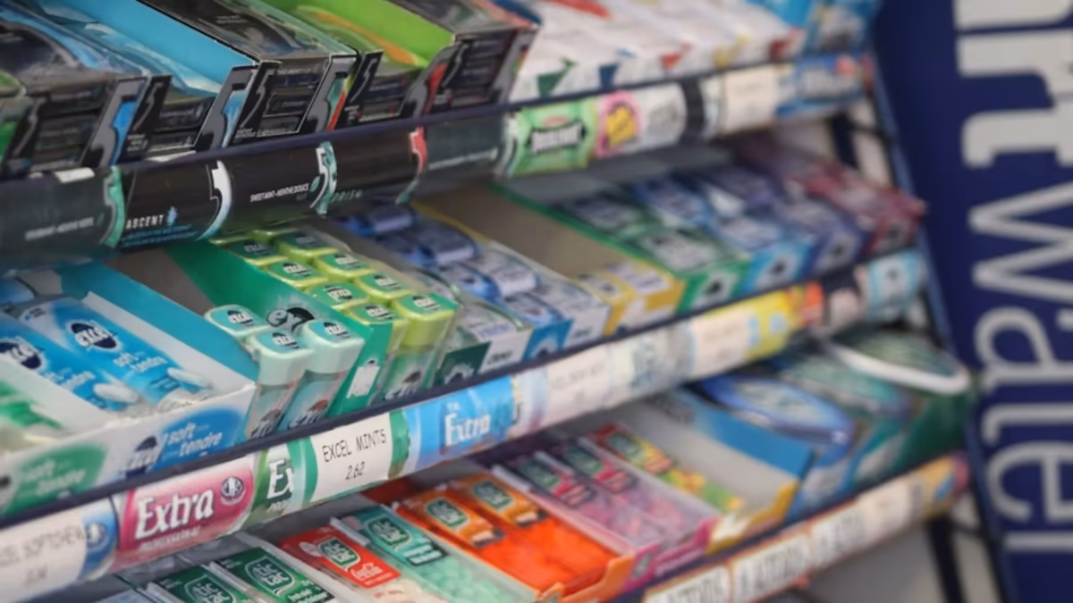 Shelves stocked with packets of chewing gum