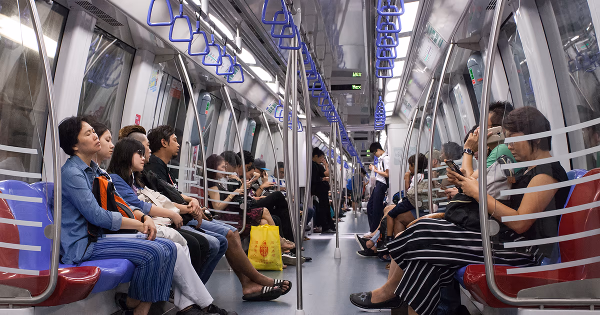 Commuters seated inside a Singapore MRT train carriage